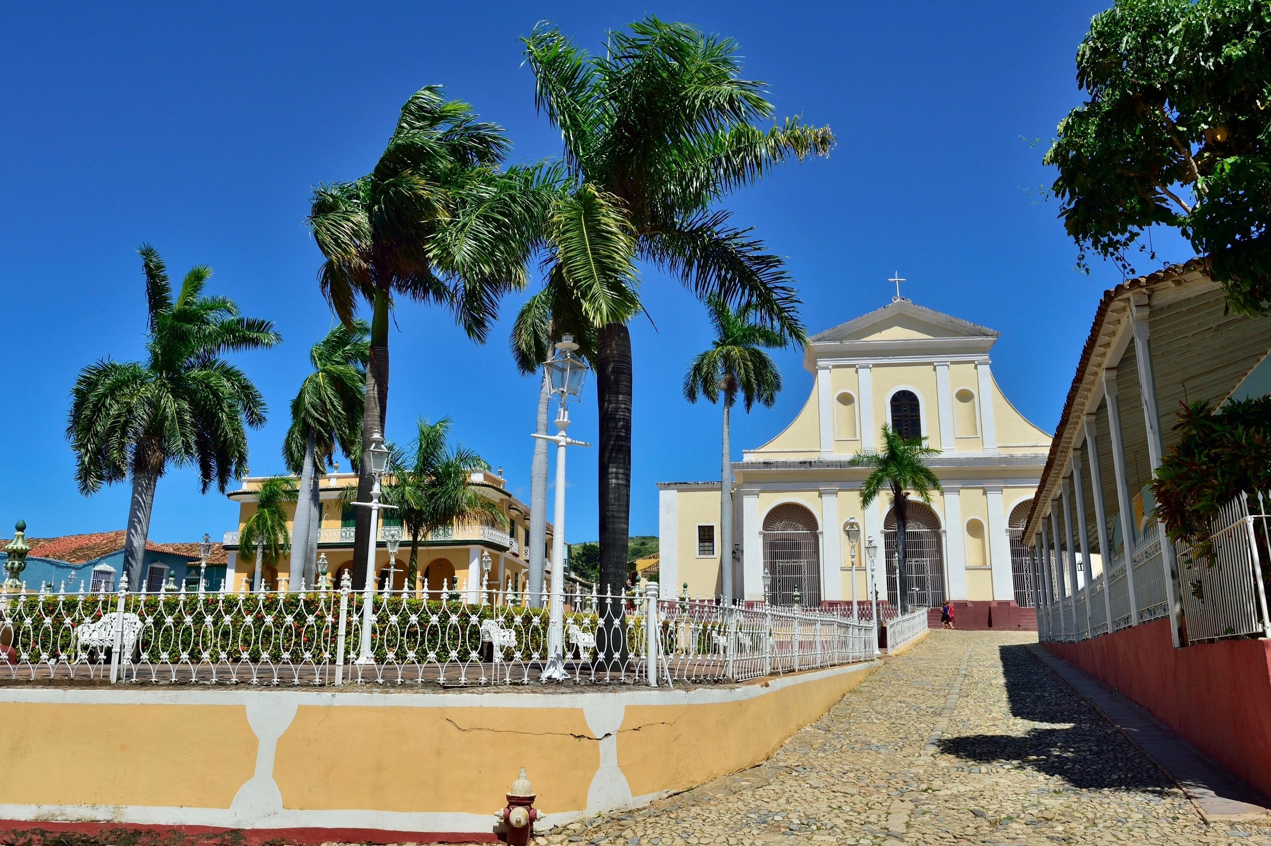 Colonial church plaza with palm trees, Cuba