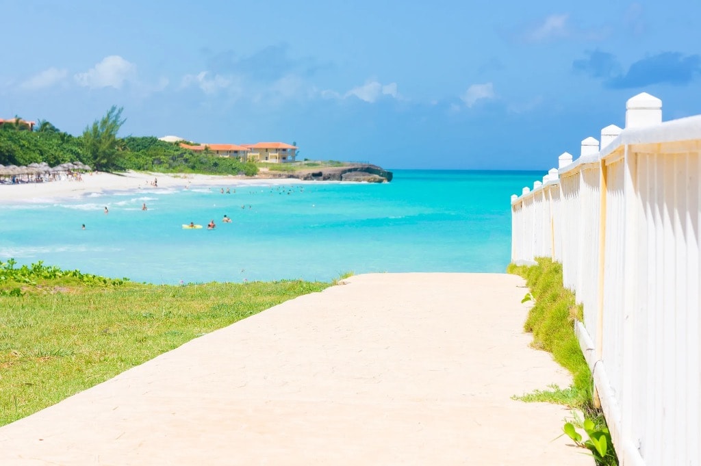 Tropical Cuba beach resort with turquoise water and white fence