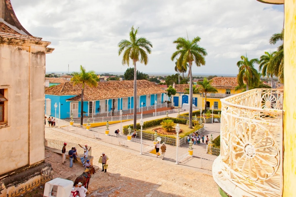 Trinidad Cuba Plaza Mayor with colorful colonial buildings and palm trees