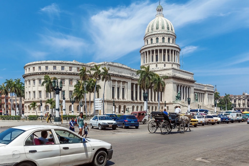 El Capitolio Havana with horse carriage and street traffic Cuba