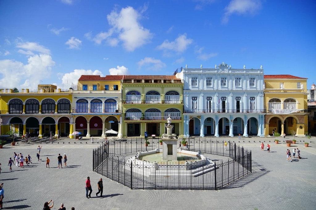 Plaza Vieja Havana colonial fountain and colorful arcaded buildings