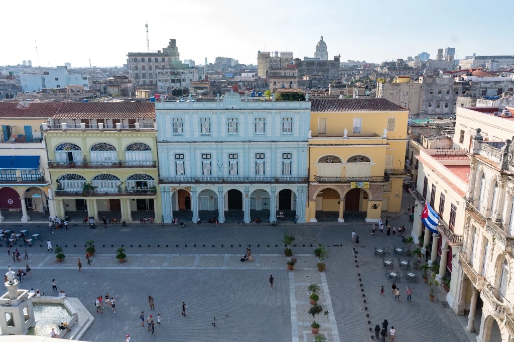 Plaza Vieja Havana aerial view with Cuban flag and Capitol dome in background