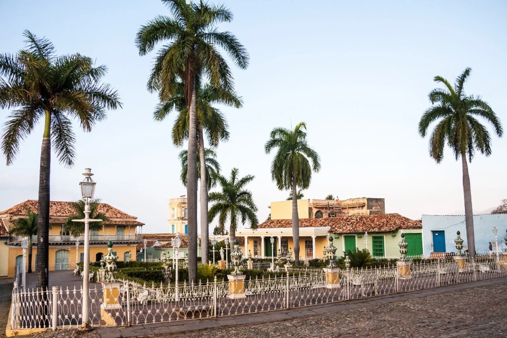 Trinidad Cuba Plaza Mayor at dawn with royal palms and colonial buildings