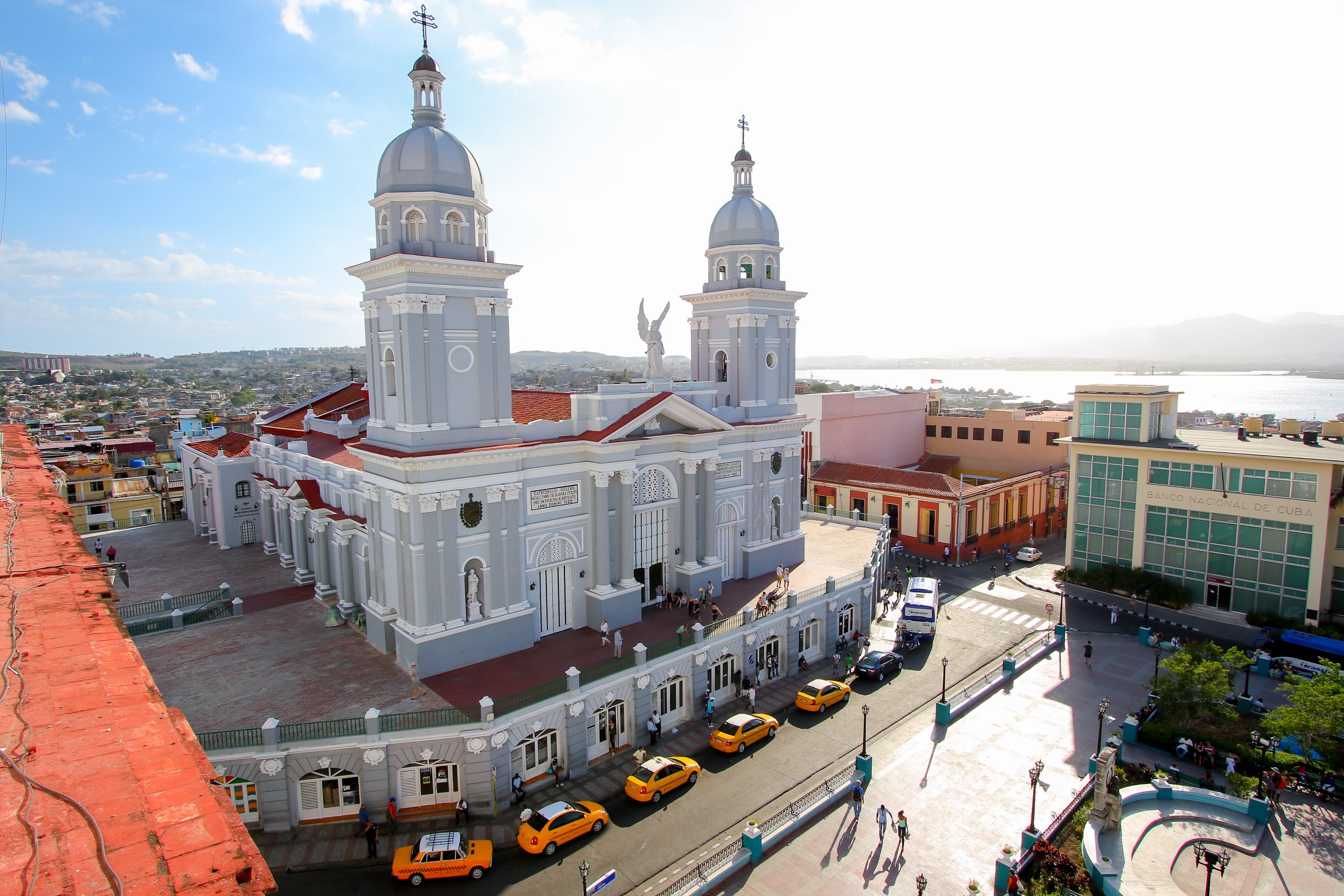 Santiago de Cuba Cathedral with twin silver domes and angel statue overlooking the city and bay, Cuba